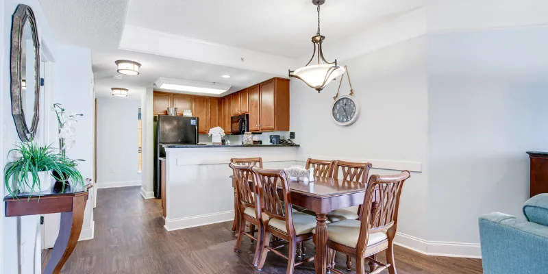 A wide view of a suite's open-plan living, dining, and kitchen area